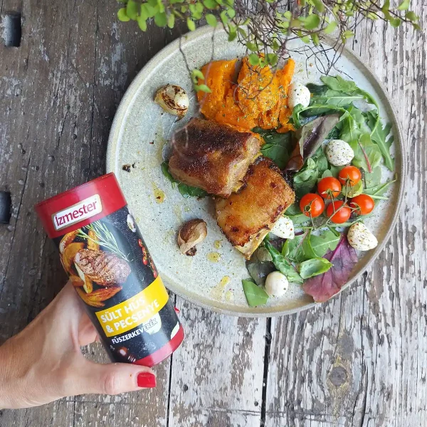 Sült oldalas salátával fehér tányéron felülnézetből mellette sült hús és pecsenye fűszerkeverék