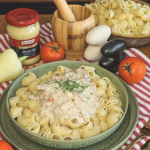 Mustáros tokány tányérban, mögötte mustár üvegben