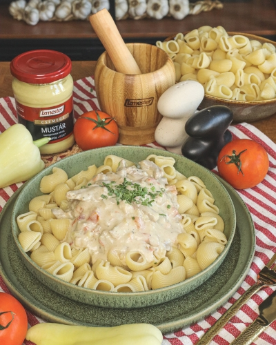 Mustáros tokány tányérban, mögötte mustár üvegben