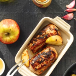 Egészben sült karaj almával tepsiben asztalon, mellette alma