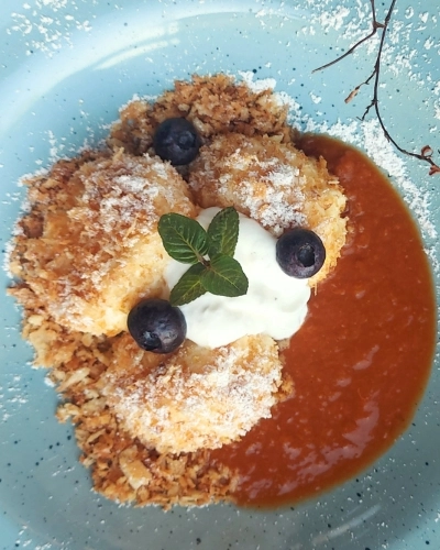 Túrógombóc epervelővel tányéron, áfonyával és porcukorral dísztíve